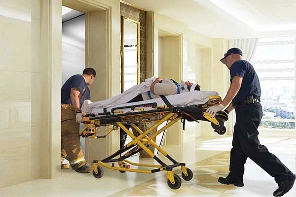 patient entering hospital elevator on bed with nurses